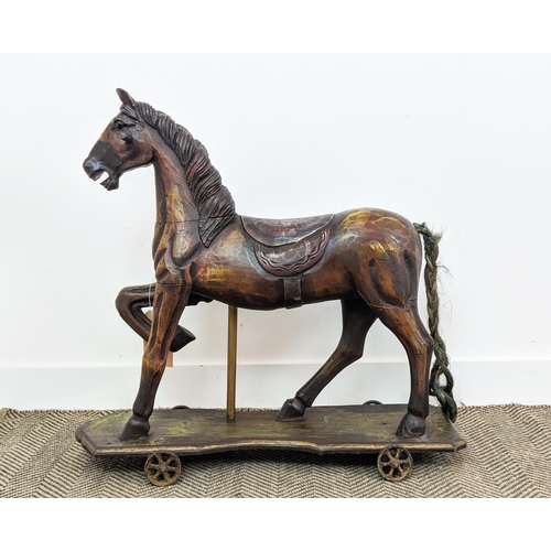 399 - SCULPTURAL HORSE, carved on a plinth with wheels, polychrome painted, 83cm L x 80cm H.