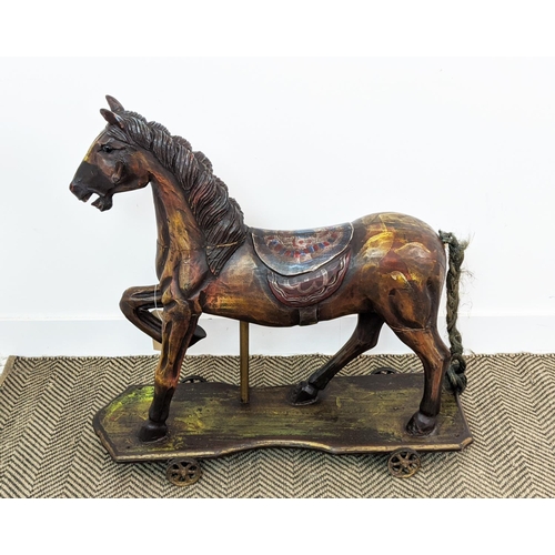 399 - SCULPTURAL HORSE, carved on a plinth with wheels, polychrome painted, 83cm L x 80cm H.