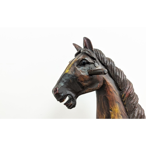 399 - SCULPTURAL HORSE, carved on a plinth with wheels, polychrome painted, 83cm L x 80cm H.