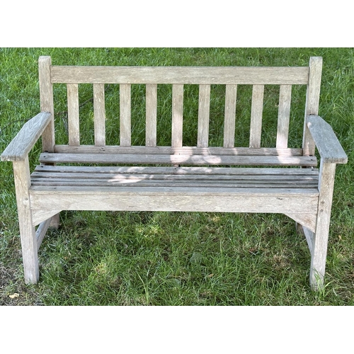 120 - GARDEN BENCH, well weathered slatted teak with flat arms, 82cm H 127cm W.