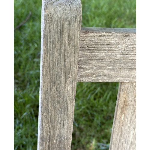 120 - GARDEN BENCH, well weathered slatted teak with flat arms, 82cm H 127cm W.