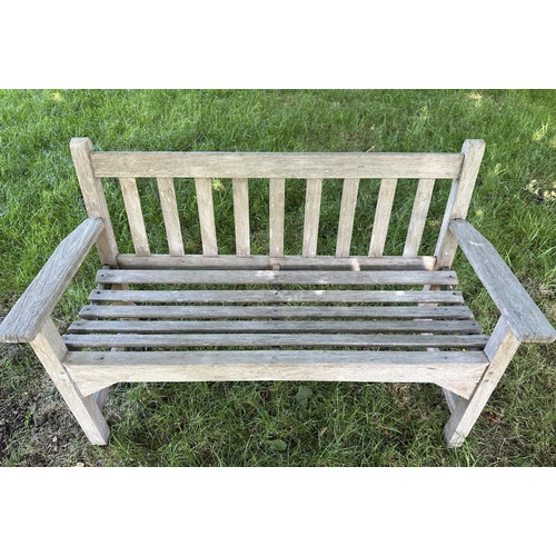 120 - GARDEN BENCH, well weathered slatted teak with flat arms, 82cm H 127cm W.