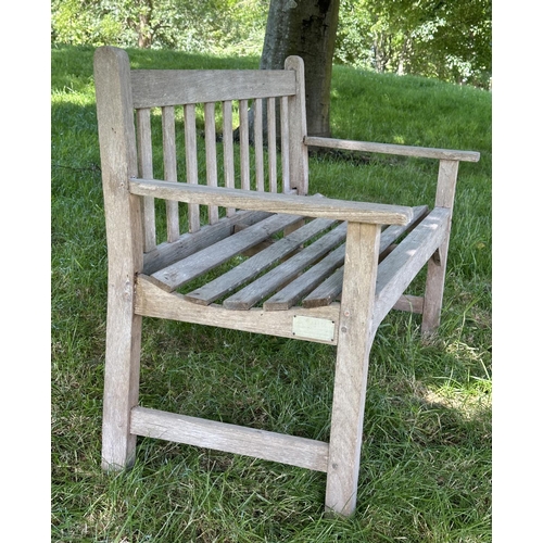 120 - GARDEN BENCH, well weathered slatted teak with flat arms, 82cm H 127cm W.