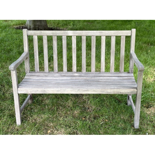 124 - GARDEN BENCH, well weathered slatted teak with shaped arms, 89cm H x 120cm W.