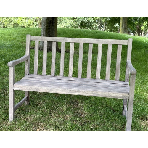 124 - GARDEN BENCH, well weathered slatted teak with shaped arms, 89cm H x 120cm W.