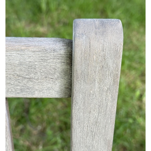 124 - GARDEN BENCH, well weathered slatted teak with shaped arms, 89cm H x 120cm W.