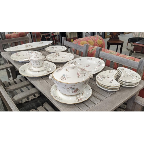 25 - ETIENNE PART DINNER SERVICE, comprising a fish and oyster serving dishes, a soup tureen cover, eight... 