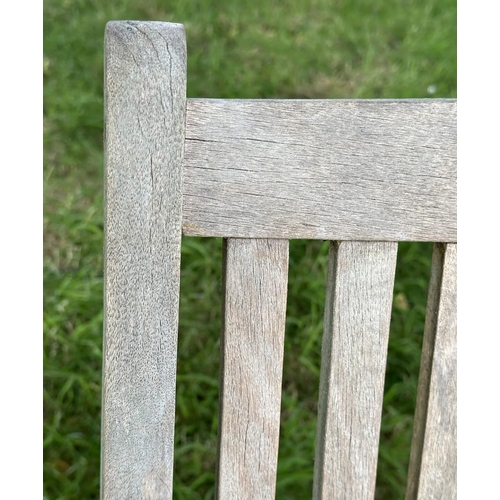 129 - GARDEN BENCH, weathered teak of slatted construction with slightly arch shaped back and curved arms,... 