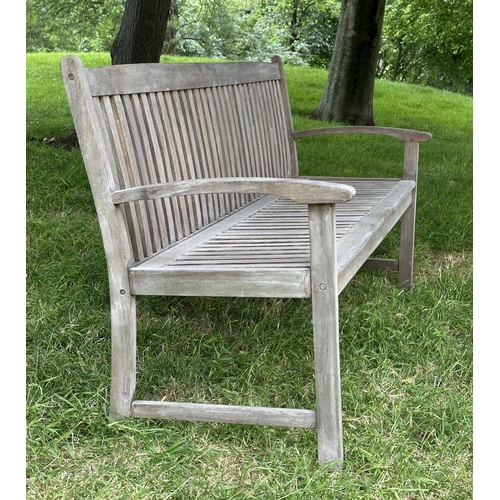 129 - GARDEN BENCH, weathered teak of slatted construction with slightly arch shaped back and curved arms,... 