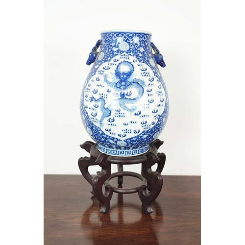 391 - CHINESE STYLE VASE, blue and white ceramic on wooden stand, 72cm H x 40cm.