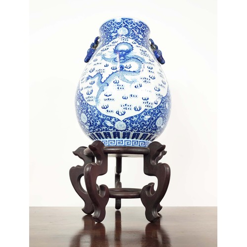 391 - CHINESE STYLE VASE, blue and white ceramic on wooden stand, 72cm H x 40cm.