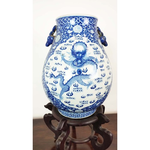 391 - CHINESE STYLE VASE, blue and white ceramic on wooden stand, 72cm H x 40cm.