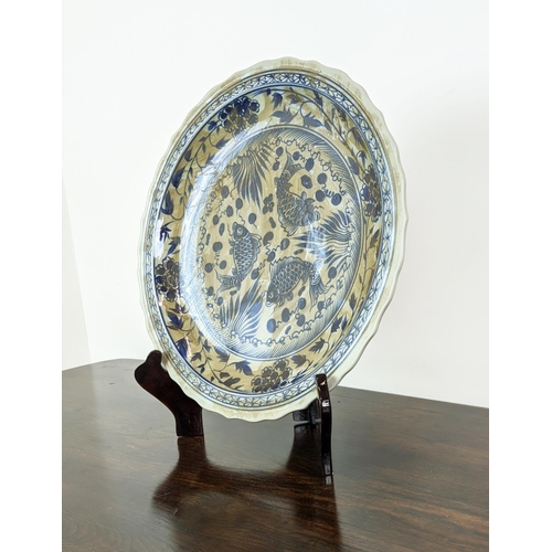 378 - CHINESE STYLE CHARGER, blue and white ceramic on wooden stand, 58cm diam.