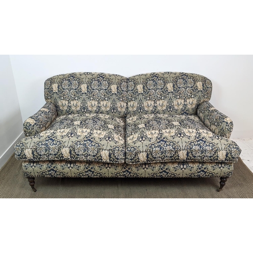 221 - SOFA, Howard style in William Morris honeysuckle patterned upholstery with brass front castors, 95cm... 