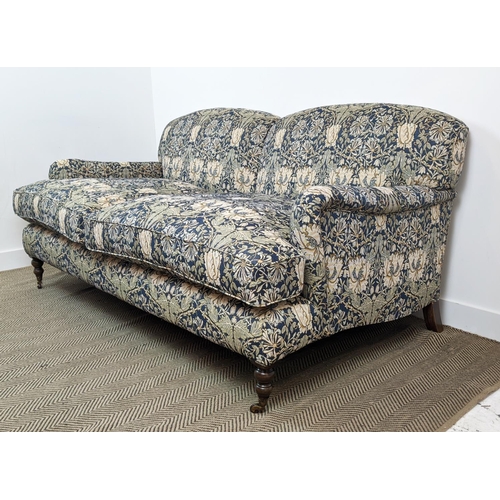 221 - SOFA, Howard style in William Morris honeysuckle patterned upholstery with brass front castors, 95cm... 