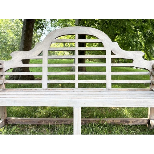 264 - LUTYENS STYLE GARDEN BENCH, well weathered teak of slatted and dowelled construction after the desig... 