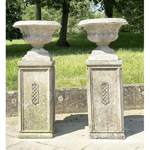 269 - GARDEN URNS, a pair, weathered reconstituted stone each on plinth bases with lattice panels, 119cm H... 