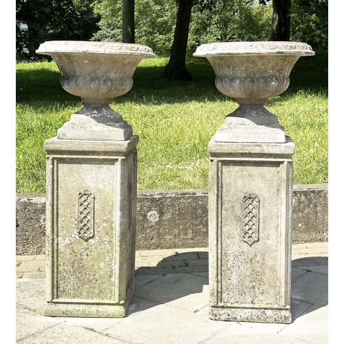 269 - GARDEN URNS, a pair, weathered reconstituted stone each on plinth bases with lattice panels, 119cm H... 