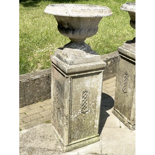 269 - GARDEN URNS, a pair, weathered reconstituted stone each on plinth bases with lattice panels, 119cm H... 