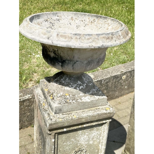 269 - GARDEN URNS, a pair, weathered reconstituted stone each on plinth bases with lattice panels, 119cm H... 