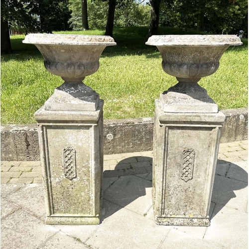 269 - GARDEN URNS, a pair, weathered reconstituted stone each on plinth bases with lattice panels, 119cm H... 