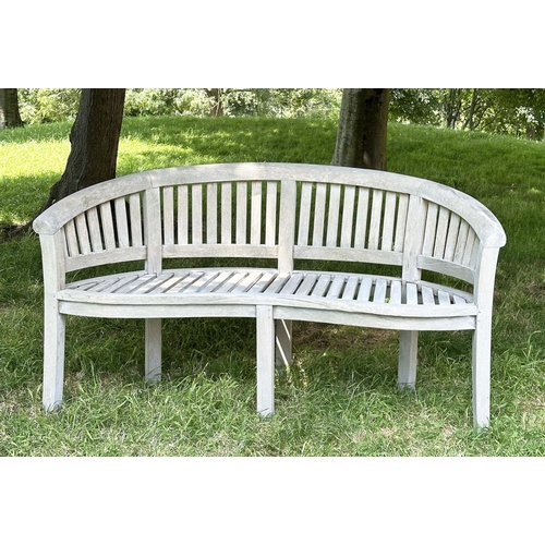 271 - BANANA GARDEN BENCH, well weathered teak of slatted construction with rounded back and arms, 158cm W... 