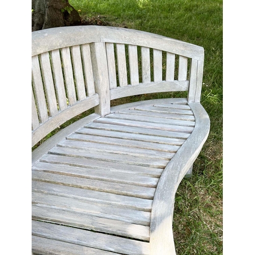 271 - BANANA GARDEN BENCH, well weathered teak of slatted construction with rounded back and arms, 158cm W... 