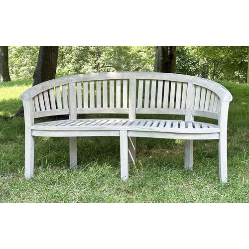 271 - BANANA GARDEN BENCH, well weathered teak of slatted construction with rounded back and arms, 158cm W... 