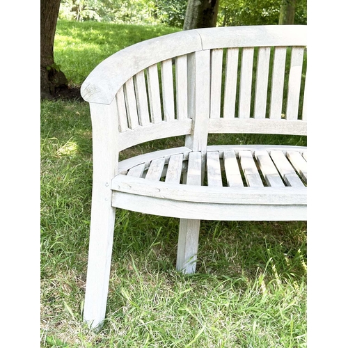 271 - BANANA GARDEN BENCH, well weathered teak of slatted construction with rounded back and arms, 158cm W... 