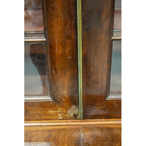 279 - BREAKFRONT LIBRARY BOOKCASE, first quarter 19th century mahogany with four glazed doors and adjustab... 