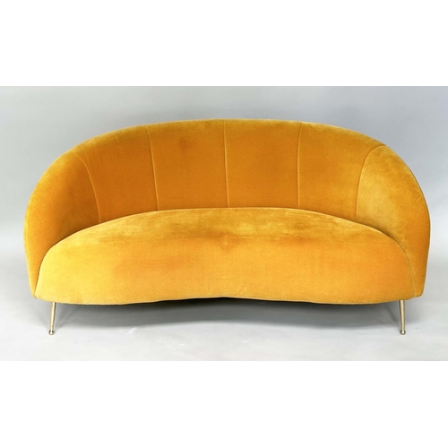 402 - HEAL'S BLOOMSBURY SOFA, soft primrose yellow velvet upholstered with curved back and splay gilt meta... 