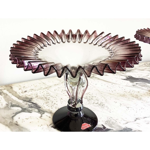 158 - MURANO GLASS TAZZE, a pair, ruffle rimmed circa 1950, clear and aubergine on pierced stem and spread... 