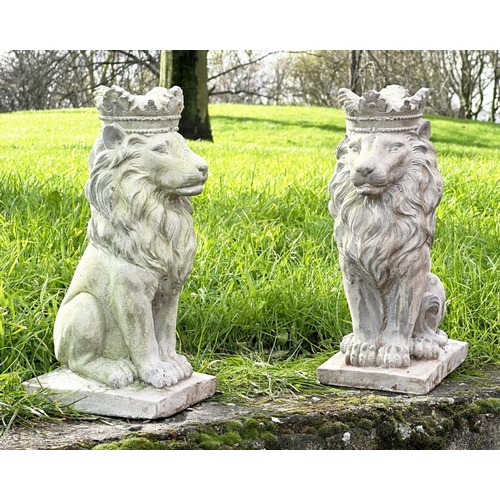 329 - GARDEN LIONS, a pair, weathered composite stone each seated and crowned, 35cm H. (2)