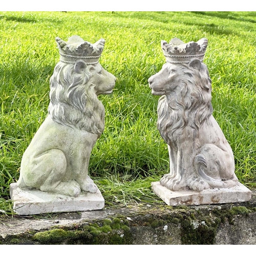 329 - GARDEN LIONS, a pair, weathered composite stone each seated and crowned, 35cm H. (2)