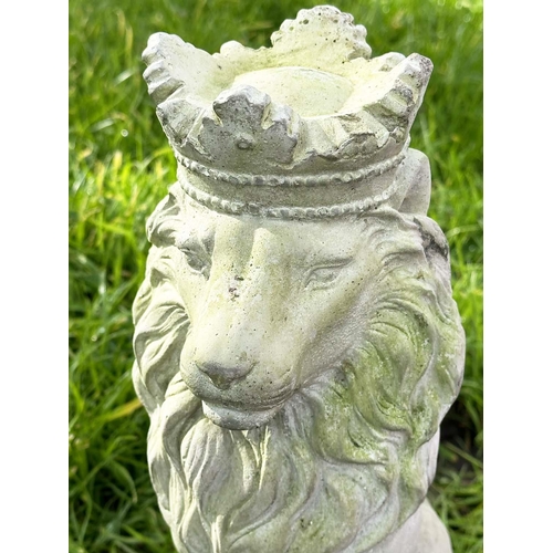 329 - GARDEN LIONS, a pair, weathered composite stone each seated and crowned, 35cm H. (2)