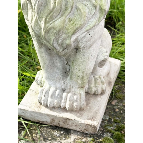 329 - GARDEN LIONS, a pair, weathered composite stone each seated and crowned, 35cm H. (2)