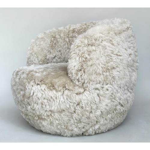 413 - SHEEPSKIN SWIVEL ARMCHAIR, real sheepskin upholstered on swivel base, 83cm W.