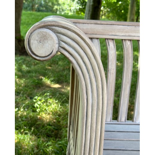 273 - COLONIAL STYLE GARDEN BENCH, weathered teak with outswept scrolled and carved uprights and slatted s... 