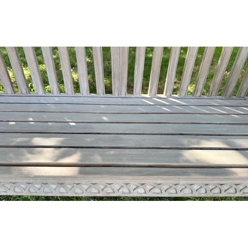 273 - COLONIAL STYLE GARDEN BENCH, weathered teak with outswept scrolled and carved uprights and slatted s... 