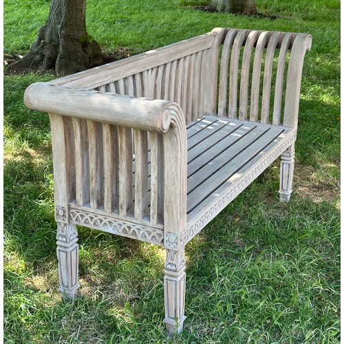 273 - COLONIAL STYLE GARDEN BENCH, weathered teak with outswept scrolled and carved uprights and slatted s... 