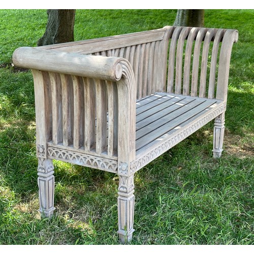 273 - COLONIAL STYLE GARDEN BENCH, weathered teak with outswept scrolled and carved uprights and slatted s... 