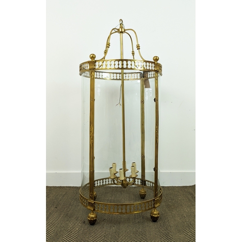 394 - HALL LANTERN, Regency style gilt metal with curved glass panels, 122cm H x 53cm W.