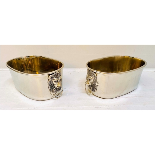 432 - CHAMPAGNE BUCKETS, a pair, polished meal with lion's head handles, 16cm H x 45cm x 26cm. (2)