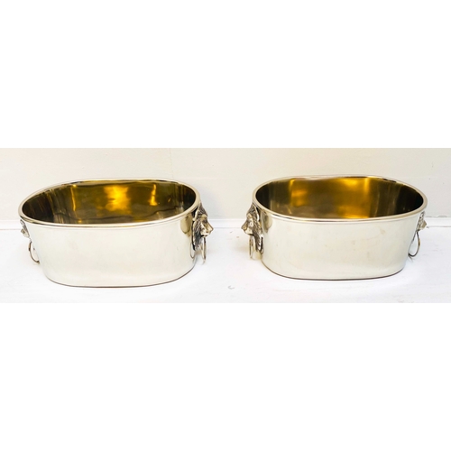 432 - CHAMPAGNE BUCKETS, a pair, polished meal with lion's head handles, 16cm H x 45cm x 26cm. (2)