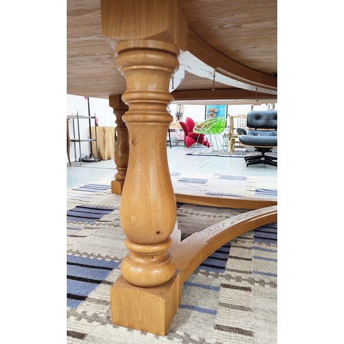 311 - DINING CENTRE TABLE, hand joined oak with circular top on tripartite baluster columns and shared str... 