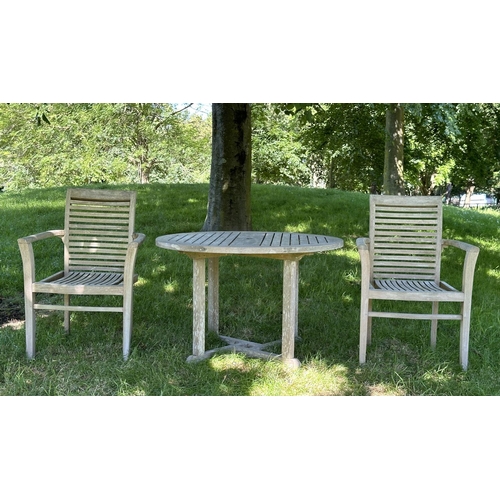 453 - GARDEN ARMCHAIRS, a pair, well weathered teak each stacking with shaped arms together with a circula... 