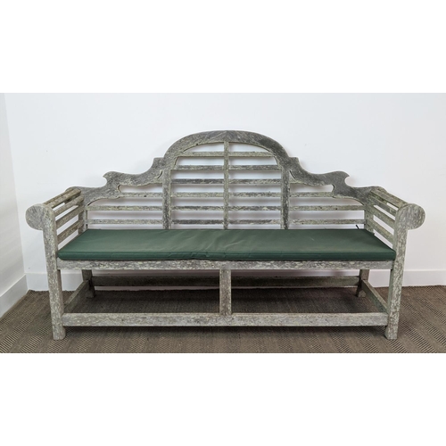 101 - GARDEN BENCH, Lutyens style in a weathered finish, 195cm x 58cm x 106cm H with green cushion.