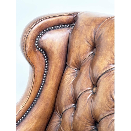 131 - LIBRARY ARMCHAIR, hand finished soft tan brown leather upholstered with button back and brass studdi... 