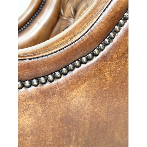 131 - LIBRARY ARMCHAIR, hand finished soft tan brown leather upholstered with button back and brass studdi... 