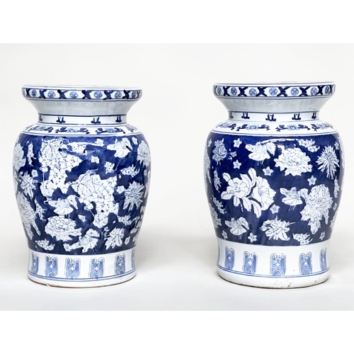 135 - CHINESE STOOLS, a pair, Chinese blue and white ceramic of vase form with fruiting vines and flowers,... 